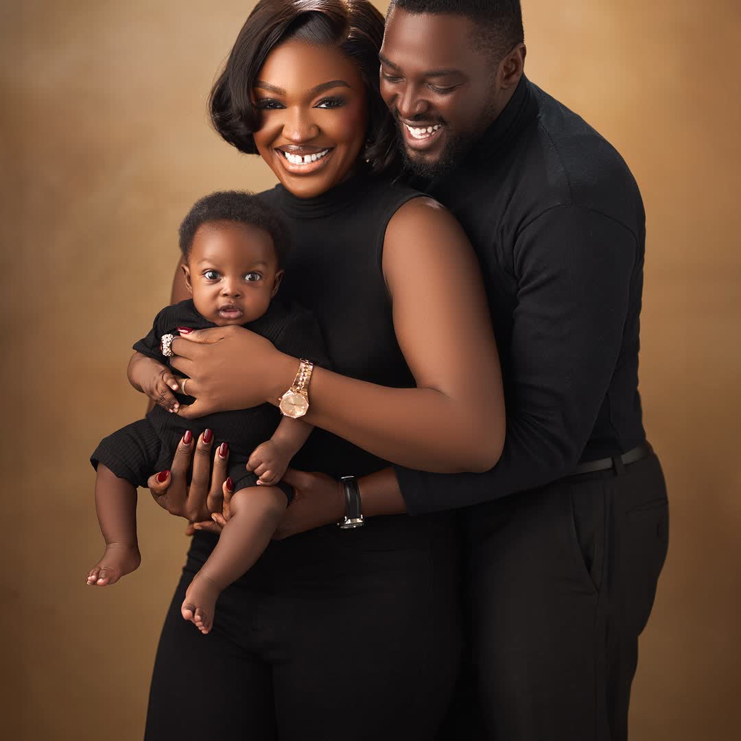 Family of three in matching black outfits