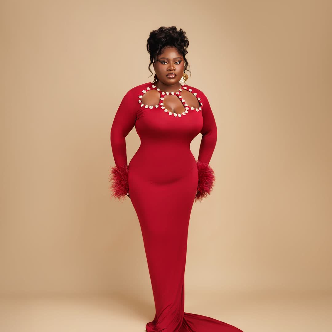 Woman in red gown with pearl cutouts